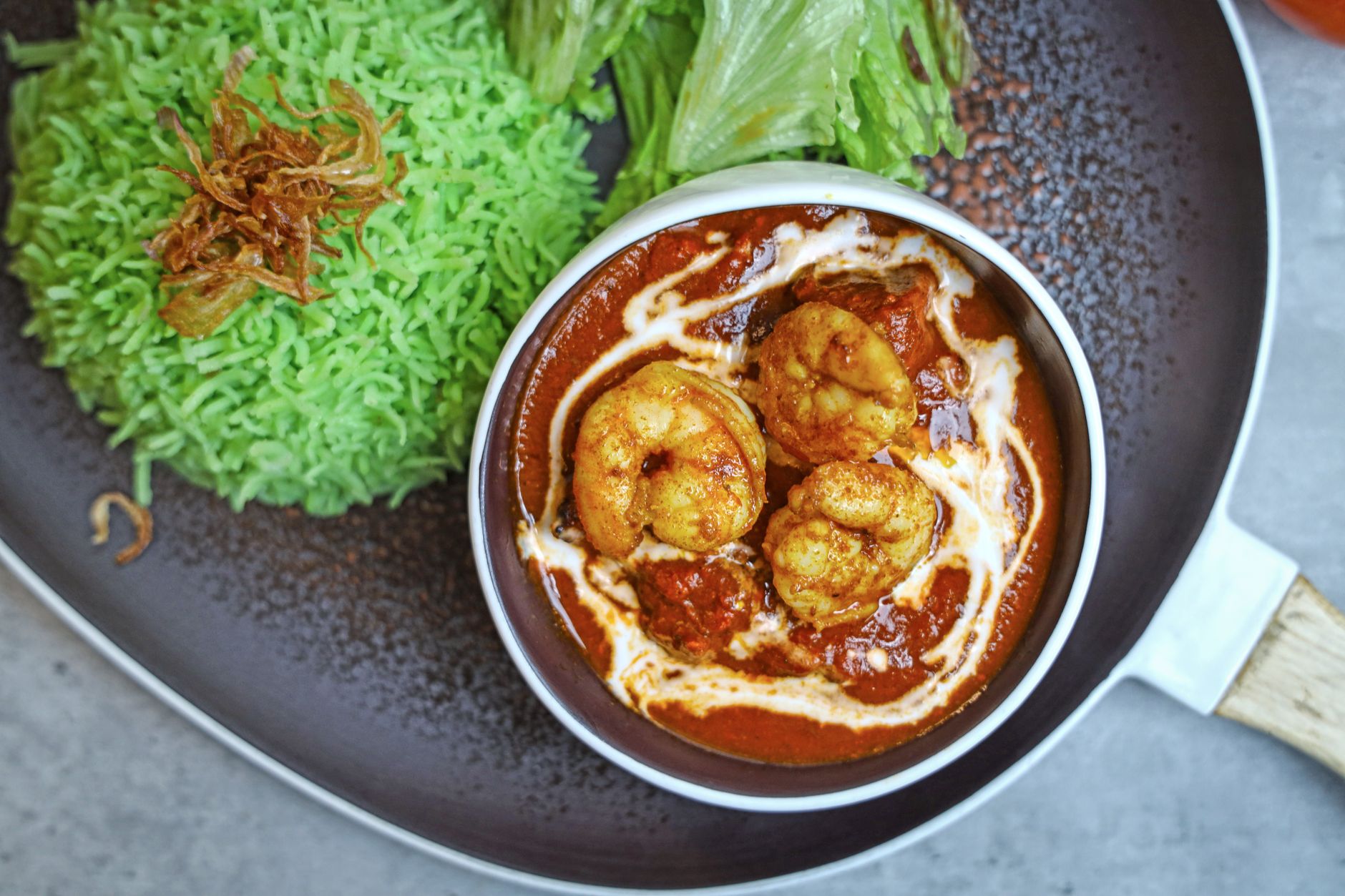 Close-up of spicy prawn curry with herbed rice